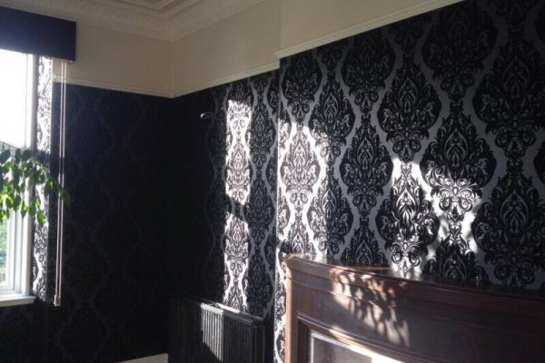 Black and white wallpaper, large segments of black in repeating diamond pattern, connected virtually end to end, with soft rounded edges, with the negative space between them coloured white