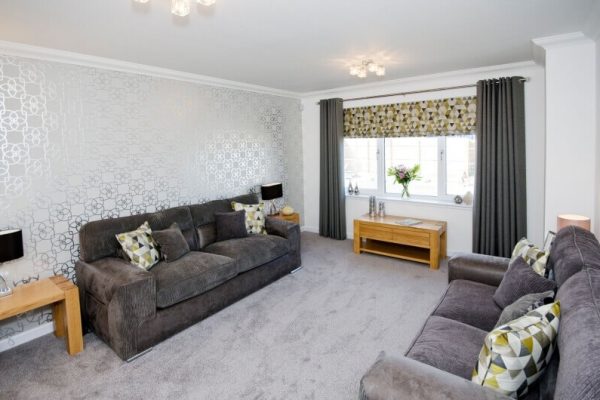 Newly decorated living room with patterned feature wall wallpaper and white painted walls