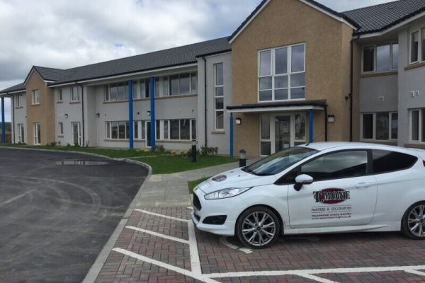 T Mone company car outside a residential care building
