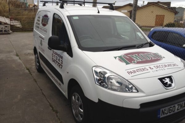T Mone Paints and Decorators company van parked ip