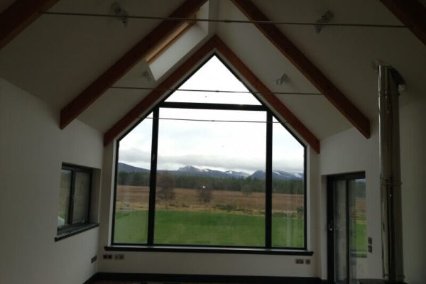 white walls in room with large windows overlooking field